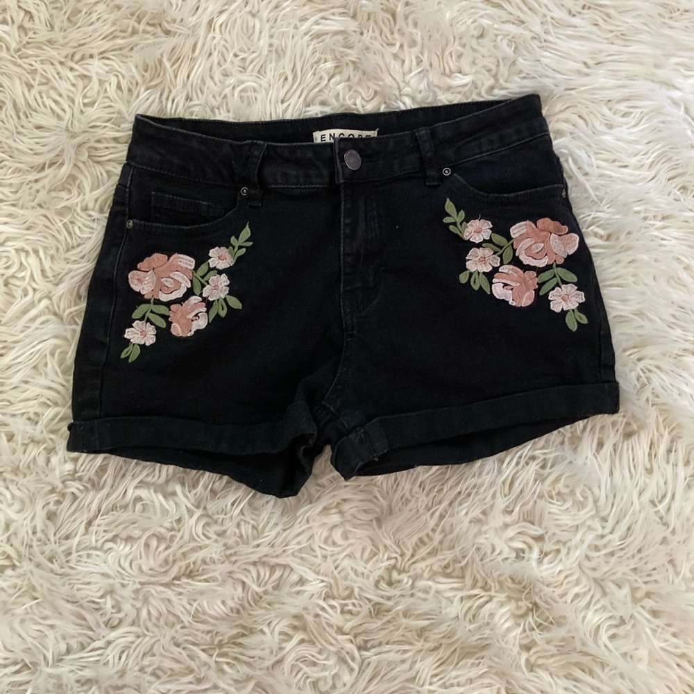 Black rose embroidered jean shorts.